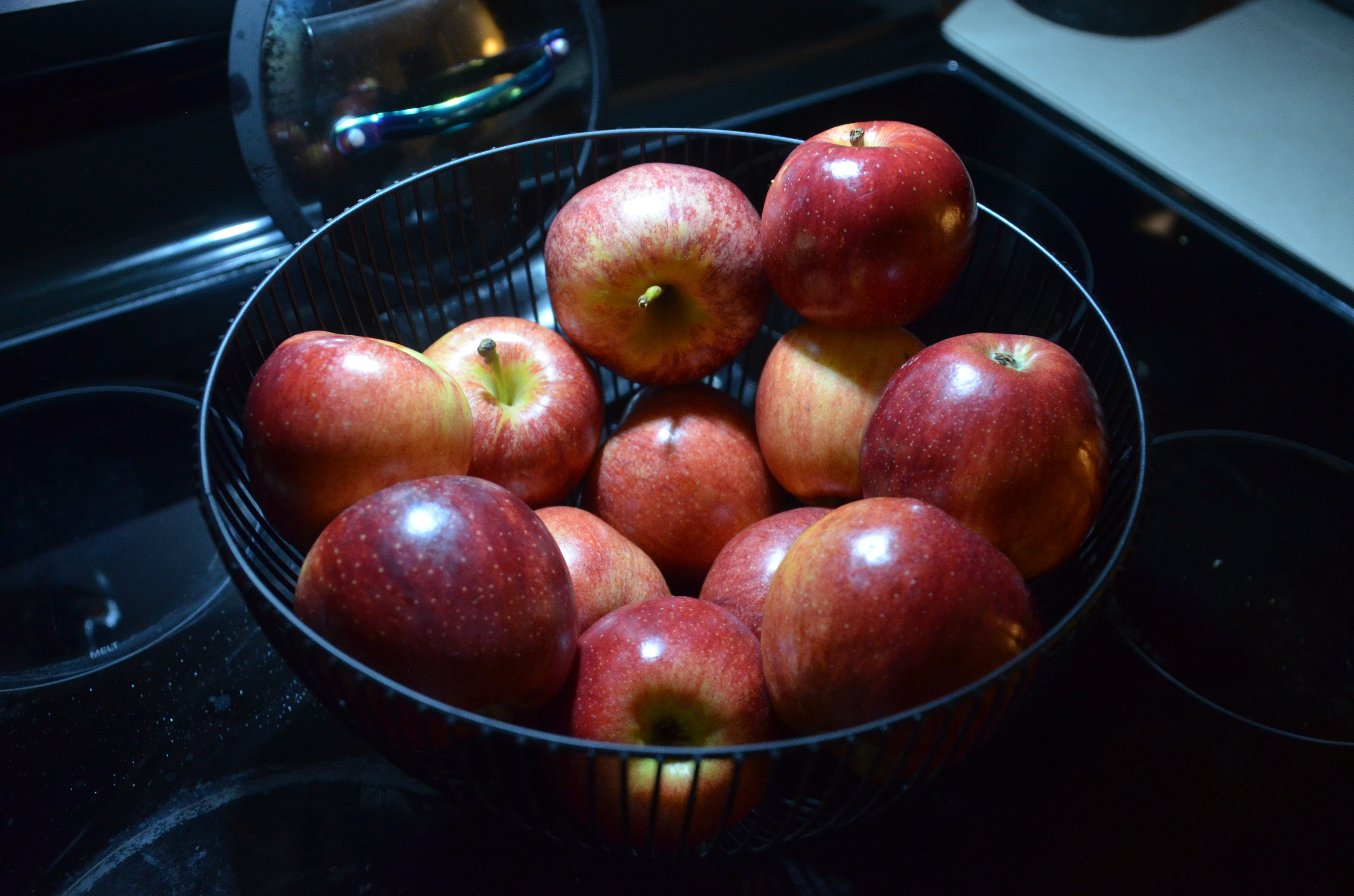 A photograph of a basket of red apples