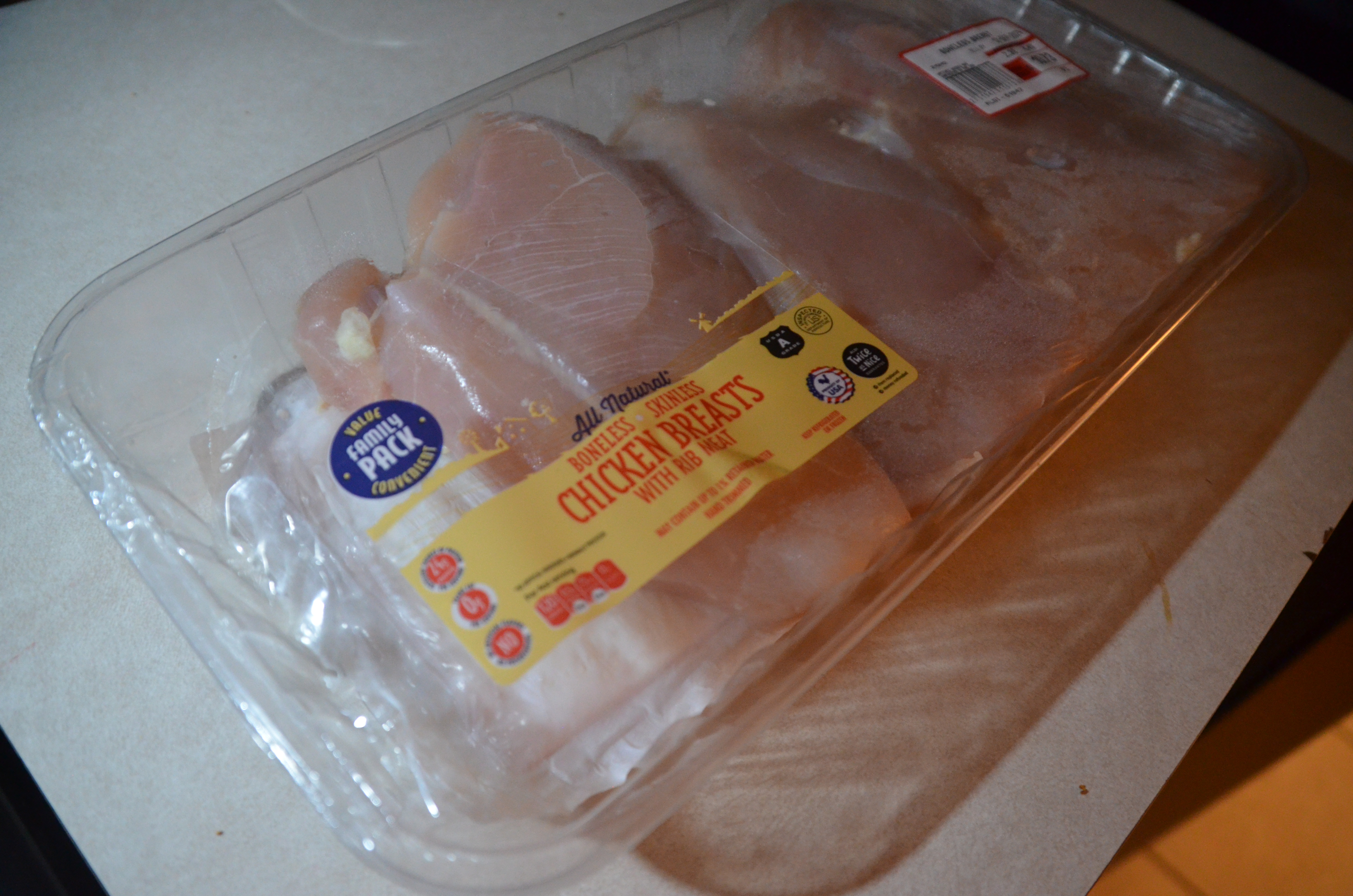 A photograph of a pack of chicken breast